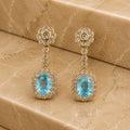Brinco flor cristal pingente pedra azul retangular